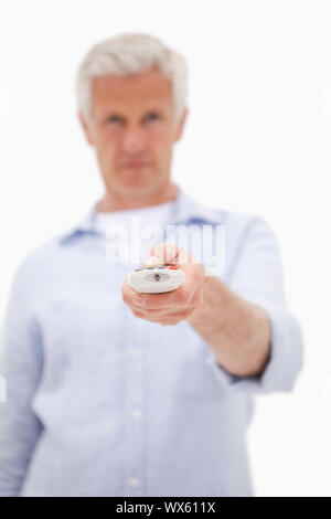 Portrait of a man using a remote against a white background Stock Photo