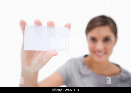 Blank business card being presented by smiling woman against a white background Stock Photo
