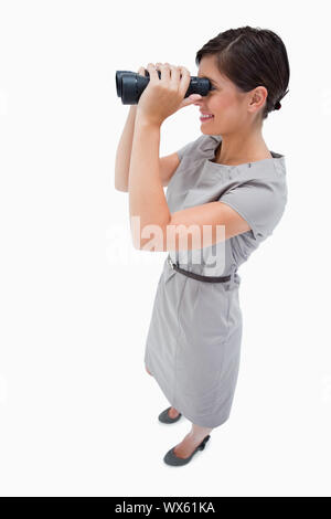 Side view of woman using spyglasses against a white background Stock Photo