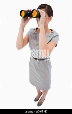 Woman using spyglasses against a white background Stock Photo