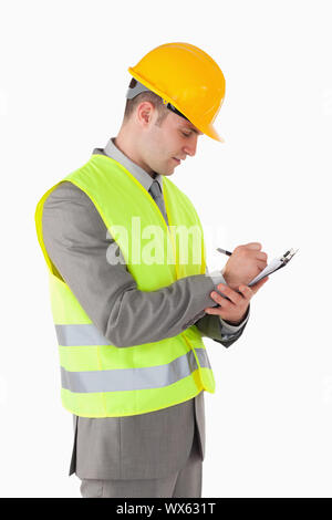 Portrait of a builder taking notes against a white background Stock Photo