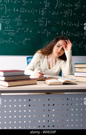 Young female math teacher in front of chalkboard Stock Photo