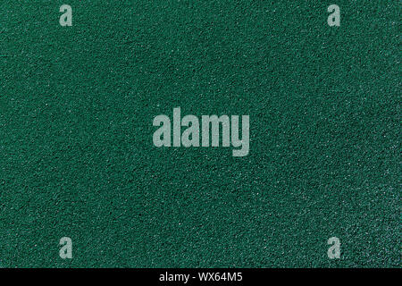 Painted rubber crumb surface. Rough colorful background. Green polyurethane material example. Copy space. Stock Photo