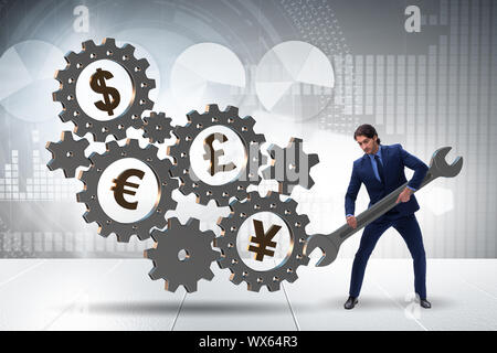 Businessman in multiple currencies concept Stock Photo