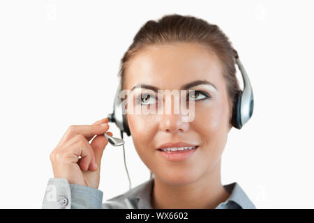 Close up of female call center agent listening closely against a white background Stock Photo