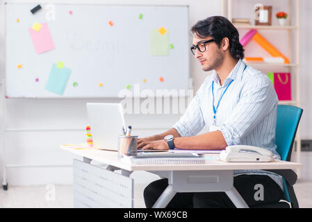 Young handsome male designer working in the office Stock Photo