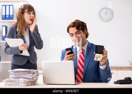 Deaf employee using hearing aid talking to boss Stock Photo