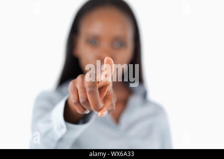 Businesswoman touching an invisible screen against a white background Stock Photo