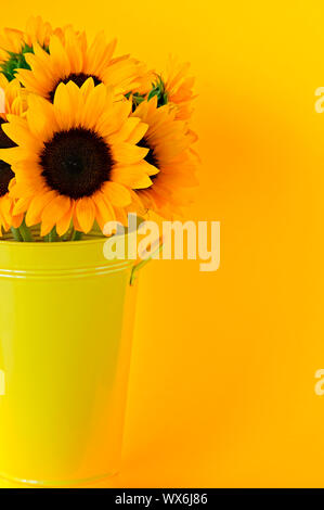 A bouquet of yellow sunflowers in a metal vase Stock Photo - Alamy