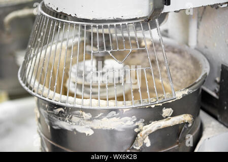 Bread Mixer In Bakery, mixing dough for baguettes in a bakery machine for  mixing dough Stock Photo - Alamy