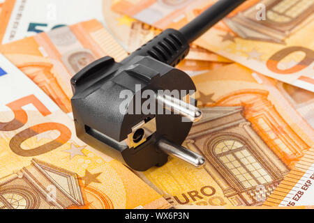Electric plug on money euro Stock Photo