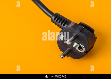 Electrical plug on orange background Stock Photo