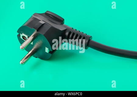 Electrical plug on green background Stock Photo