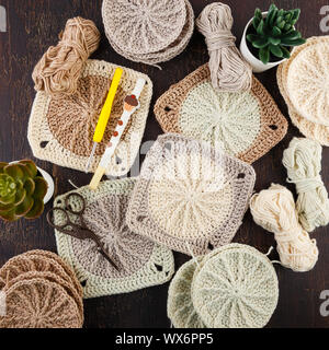 Crochet yarn, crochet hooks, and hand made granny squares. Stock Photo