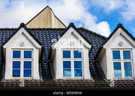mansard windows on roof in medieval house Stock Photo