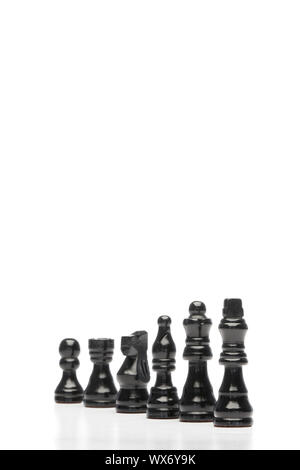 Dark pieces of chess on a white background