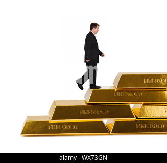 Businessman and stairs made of gold bars Stock Photo