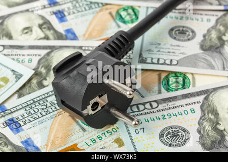 Electric plug on money Stock Photo