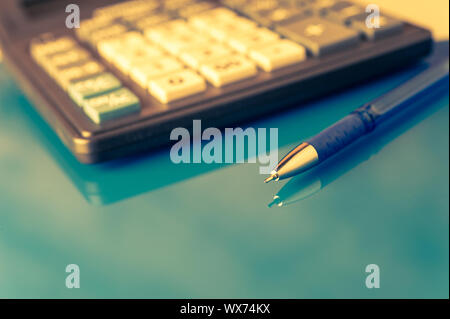Business and financial background with pen and calculator. Bookkeeping background. Stock Photo