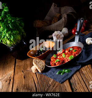 Baked mini meatballs in tomato sauce with basil Stock Photo