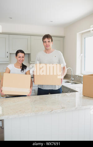 Young couple holding boxes for a relocation in their hands Stock Photo