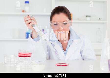 Cute scientist looking at the camera while preparing a sample Stock Photo