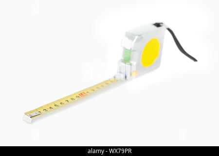 Yellow measuring tape against a white backgroung Stock Photo