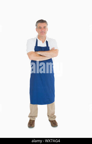 Man standing in blue apron Stock Photo