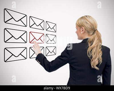 Woman touching message symbol on touchscreen interface against white background Stock Photo