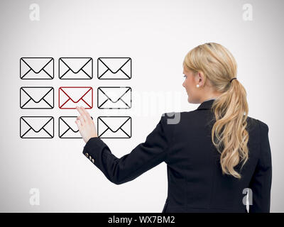 Businesswoman standing while touching at red message symbol against white background Stock Photo