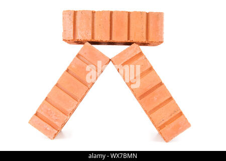 Three clay bricks being stacked against a white background Stock Photo