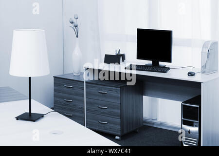 computer on a desk in a office Stock Photo