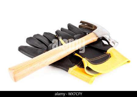 Two bulders gloves and a hammer lying on the top of them Stock Photo
