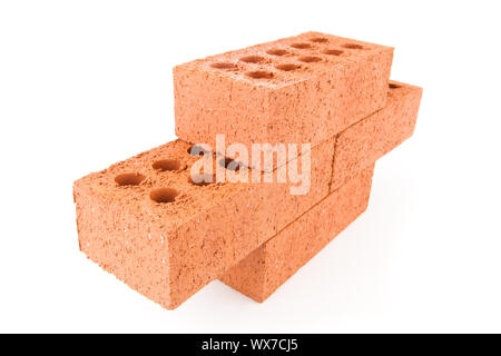 Four clay bricks stacked as a part of a wall against a white background Stock Photo