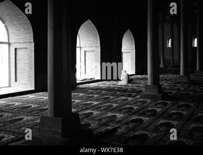 Praying in a mosque Stock Photo