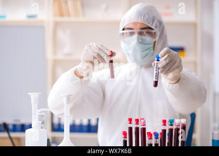 Young handsome chemist working in the lab Stock Photo