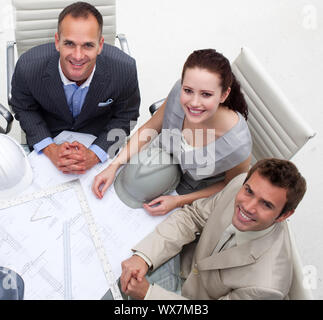 High angle of architects working with blueprints in an office Stock Photo