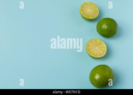 Freshly lime fruits on trendy light blue background Stock Photo