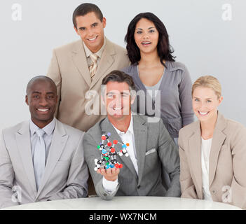 Multi-ethnic business team holding molecules in the office Stock Photo