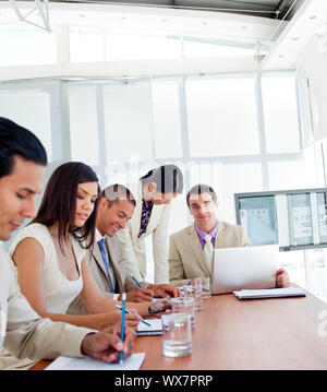 Positive business people having a meeting in a company Stock Photo