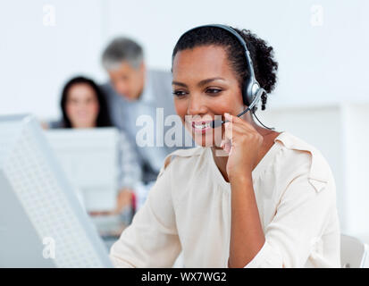 Confident businesswoman talking on headset at work Stock Photo
