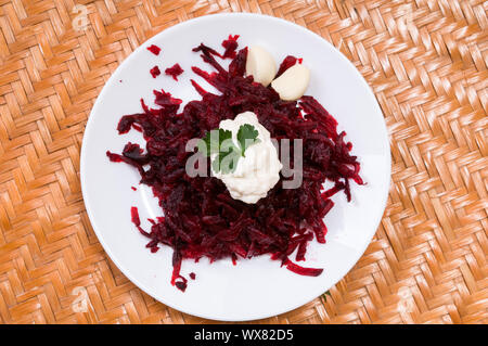Grated beets in a plate on the table close-up Stock Photo