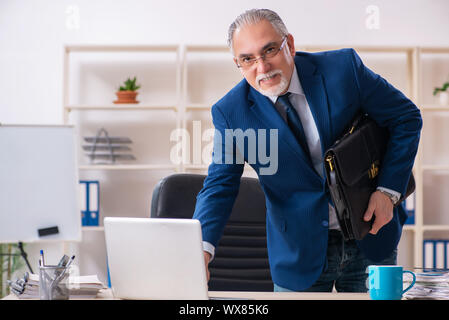 Aged male employee working in the office Stock Photo