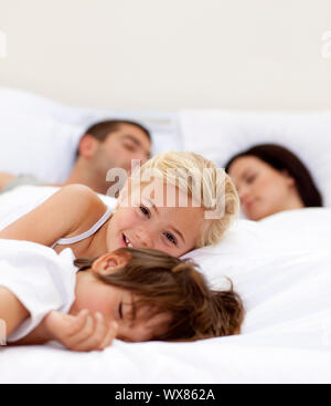 Boy lying on bed wile using smart phone Stock Photo