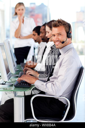 Smiling female leader managingher team in a call center Stock Photo