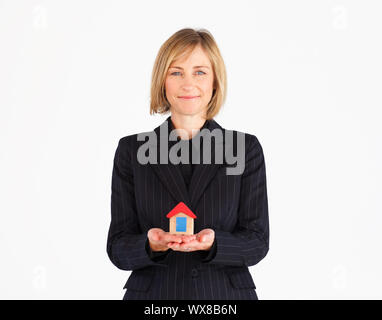 Cute businesswoman presenting a model of house Stock Photo - Alamy