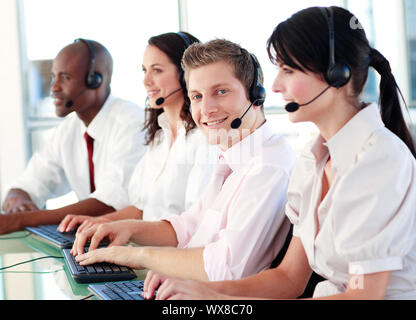 Business called centre with people on headsets Stock Photo