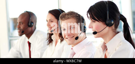 Business called centre with people on headsets Stock Photo