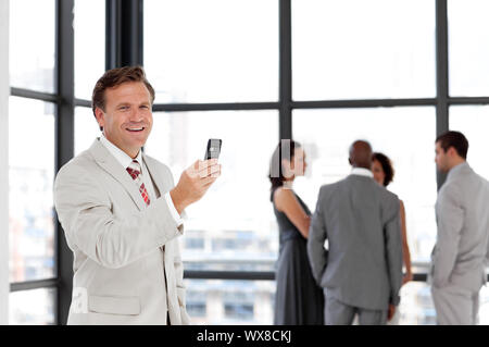 Senior Businessman being Positive with team in Background Stock Photo