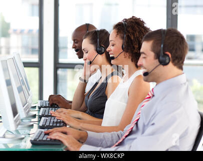 Young businesswoman working in a call center with his colleagues Stock Photo
